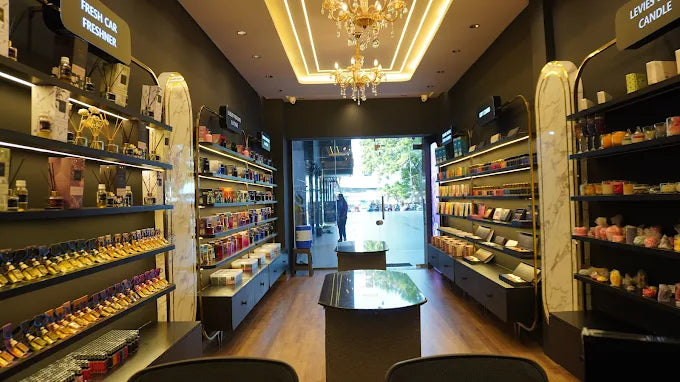 Interior of a store with shelves stocked with products and a chandelier hanging from the ceiling.