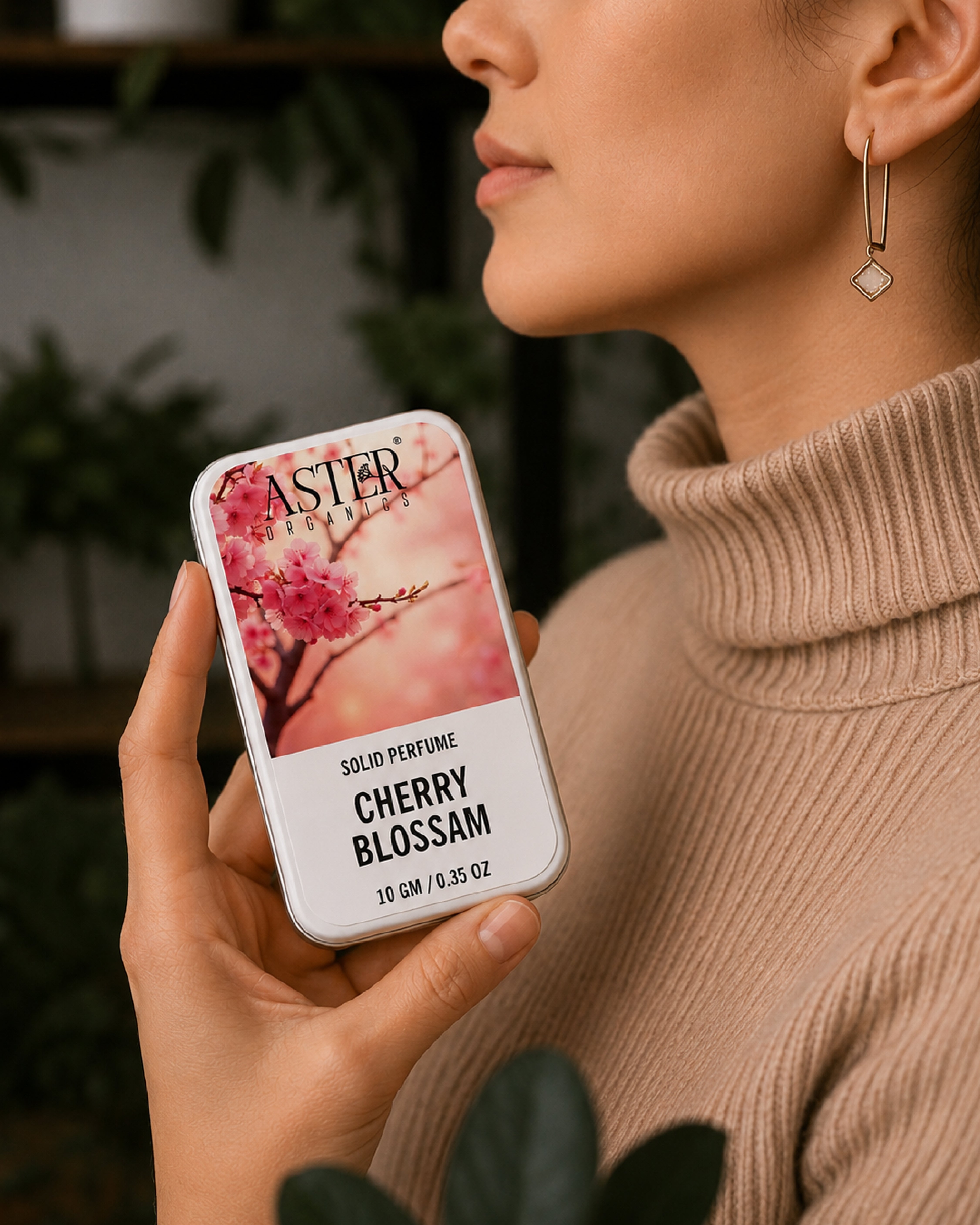 Person holding a Astier de Villatte Cherry Blossom solid perfume tin.