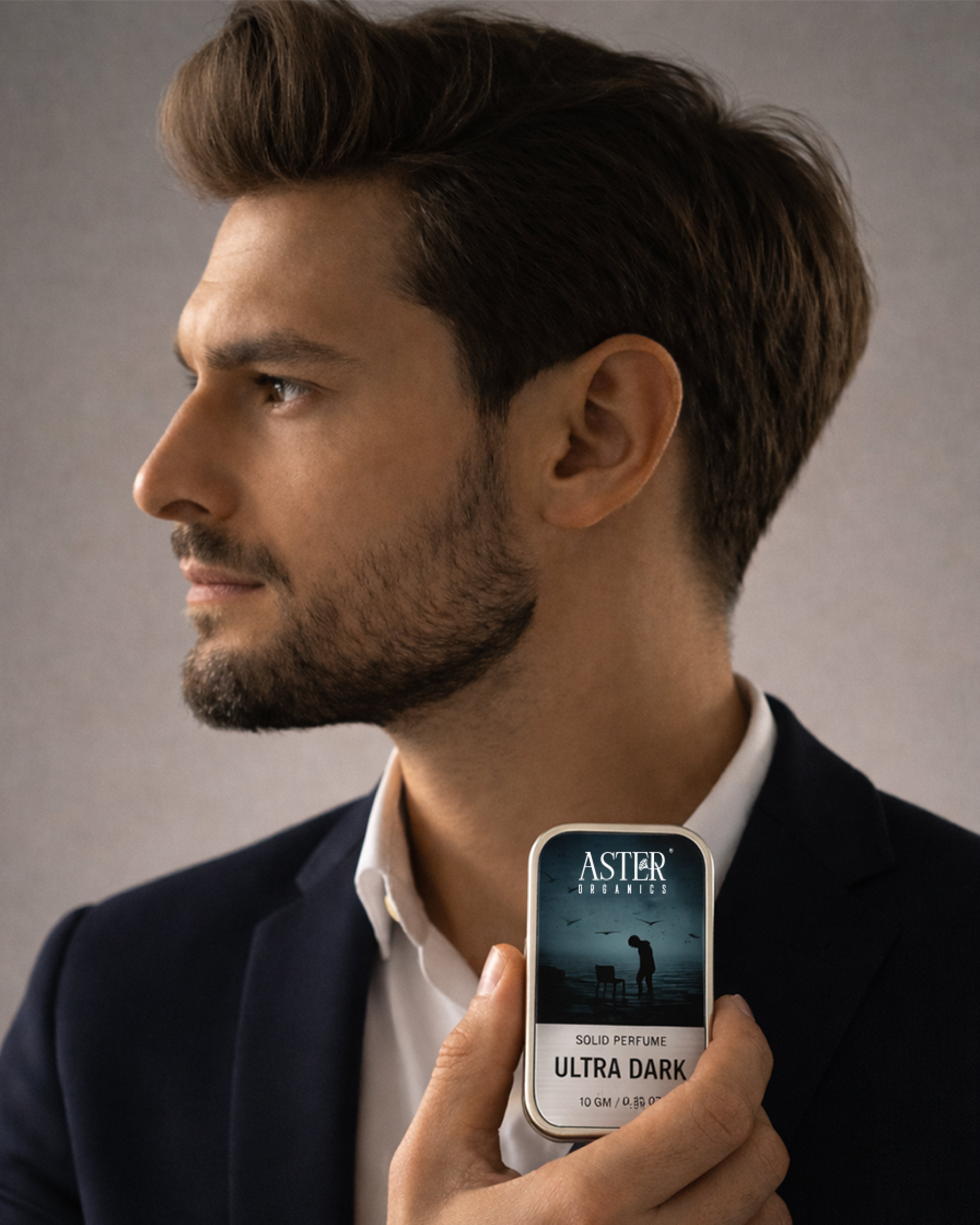 Man holding a smartphone with an Aster app interface against a neutral background